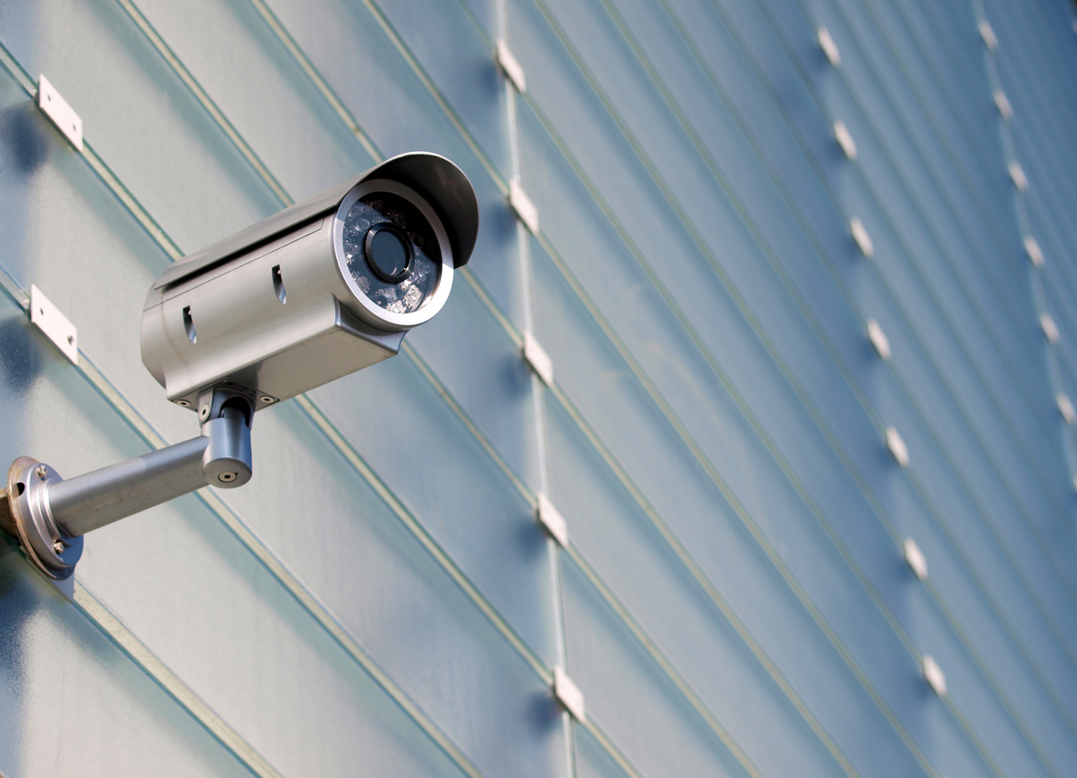 Surveillance Camera On Glass Facade
