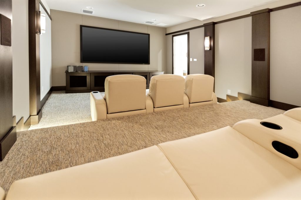 Two room home theatre with large flat screen tv.