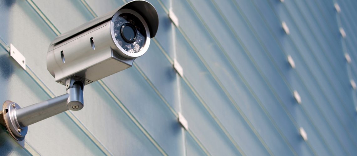 Surveillance Camera On Glass Facade